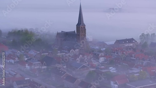 Aerial view of foggy morning over historic church and rooftops in Workum, Friesland, Netherlands. photo