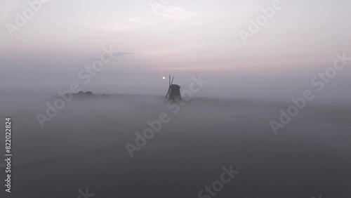 Aerial view of Windmill Bovenmolen G in foggy sunrise, Schermerhorn, Netherlands. photo