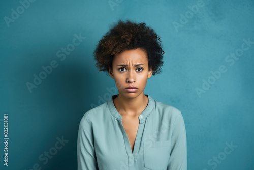 Blue background sad black independant powerful Woman realistic person portrait of young beautiful bad mood expression girl Isolated on Background racism skin color 