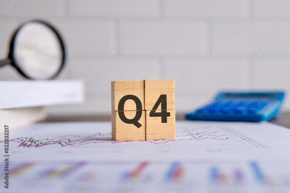Fototapeta premium Close up image of wooden cubes with alphabet Q4 on office desk. Fourth quarter concept.