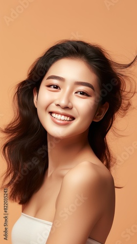 Brown background Happy Asian Woman Portrait of young beautiful Smiling Woman good mood Isolated on Background Skin Care Face Beauty Product Banner 