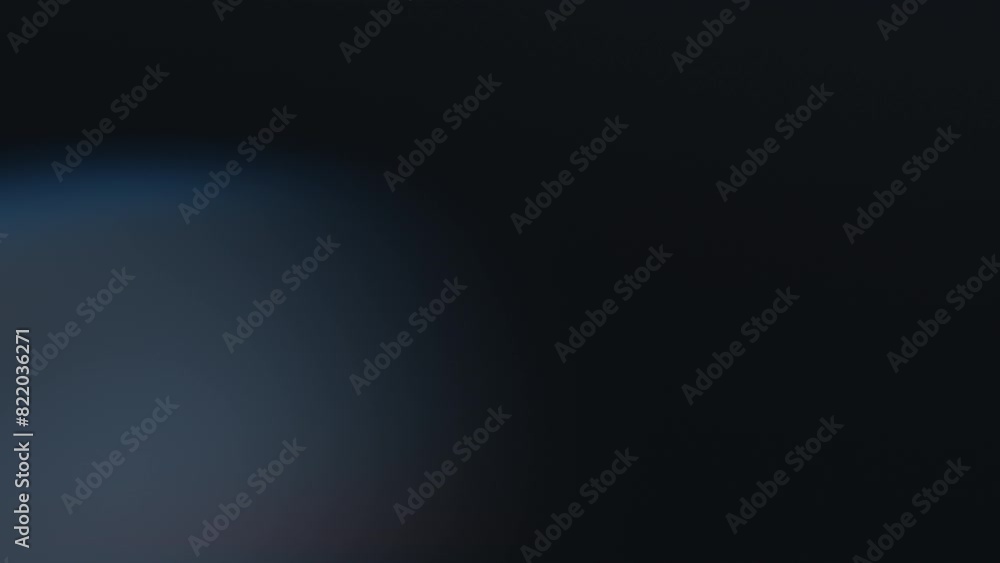 Abstract effect of the blurry bokeh lights moving on a black background