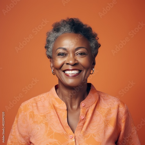 Coral Background Happy black american independant powerful Woman. Portrait of older mid aged person beautiful Smiling girl Isolated on Background ethnic 