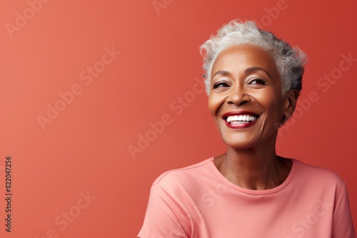 Coral Background Happy black american independant powerful Woman. Portrait of older mid aged person beautiful Smiling girl Isolated on Background ethnic 