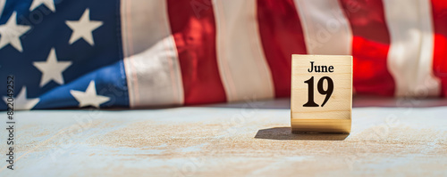 commemorating juneteenth with American flag and wooden block calendar set on June 19th