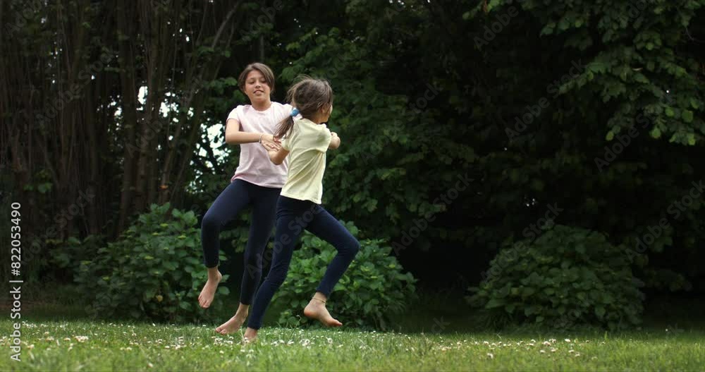 Super slow motion of carefree happy teen girls sisters friends are having fun to play together in garden outside his house on a sunny day. Childhood, family fun, freedom and happiness. Super slow motion of carefree happy teen girls sisters friends are having fun to play together in garden outside his house on a sunny day. Childhood, family fun, freedom and happiness.