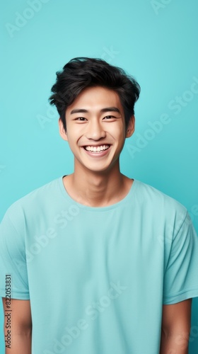 Cyan Background Happy asian man realistic person portrait of young teenage beautiful Smiling boy good mood Isolated on Background ethnic diversity equality acceptance