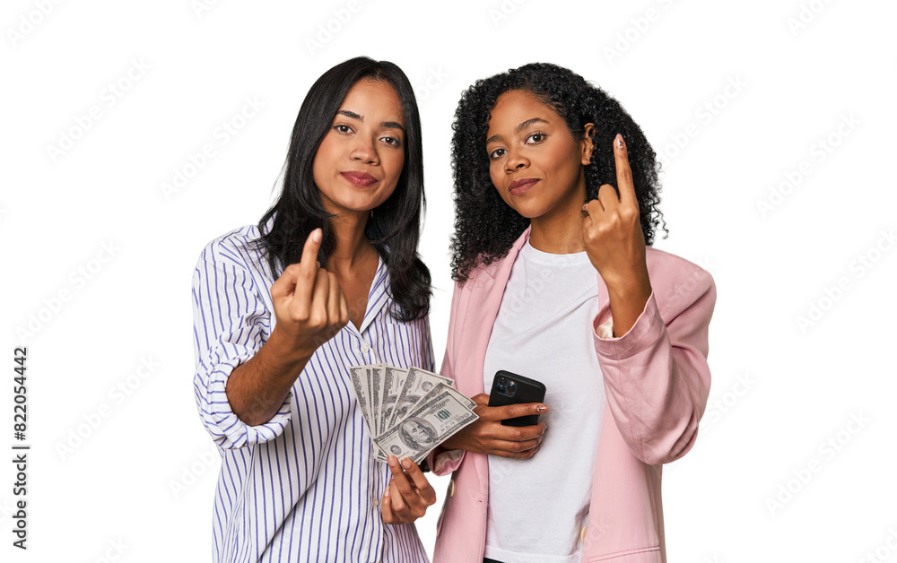 Latin businesswomen with money, phone pointing with finger at you as if inviting come closer. Latin businesswomen with money, phone pointing with finger at you as if inviting come closer.
