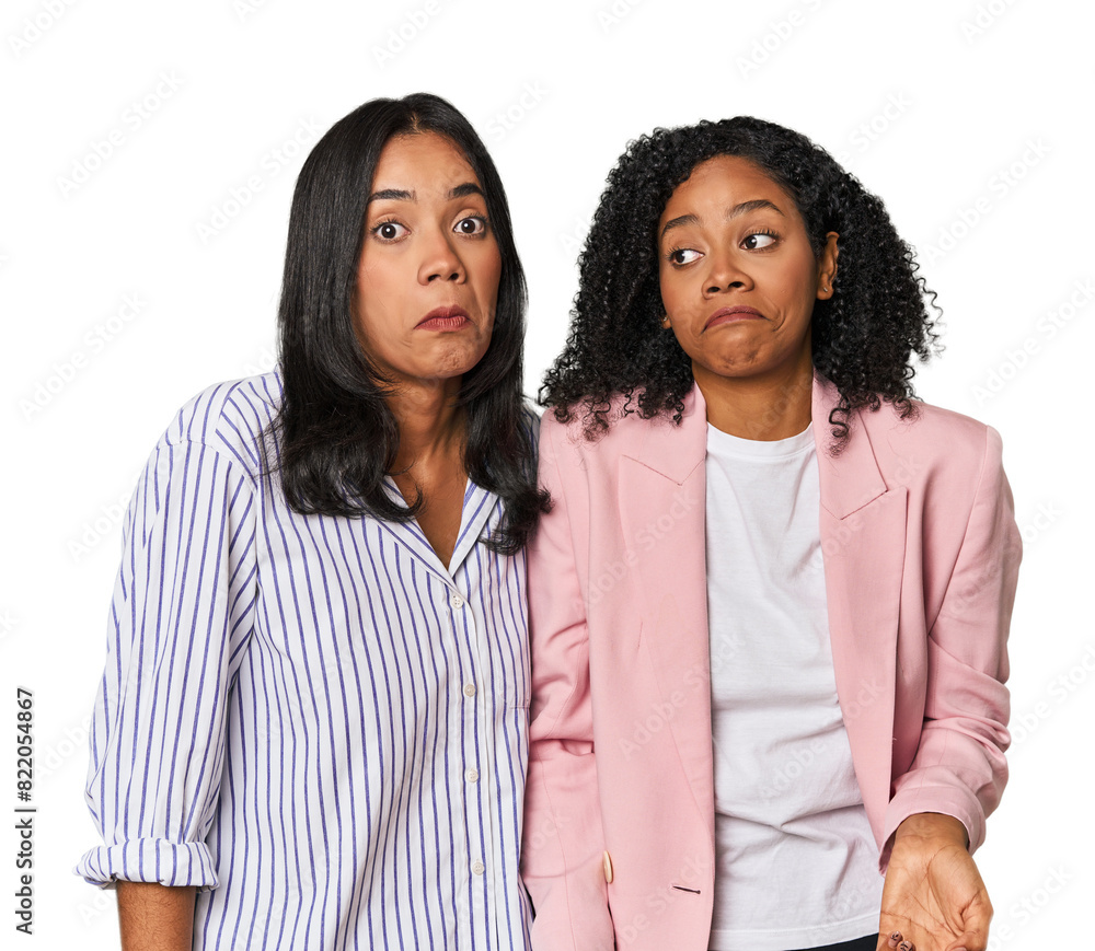 Young Latin businesswomen in studio shrugs shoulders and open eyes confused. Young Latin businesswomen in studio shrugs shoulders and open eyes confused.