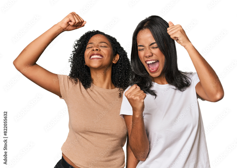 Young Latin friends in studio raising fist after a victory, winner concept. Young Latin friends in studio raising fist after a victory, winner concept.