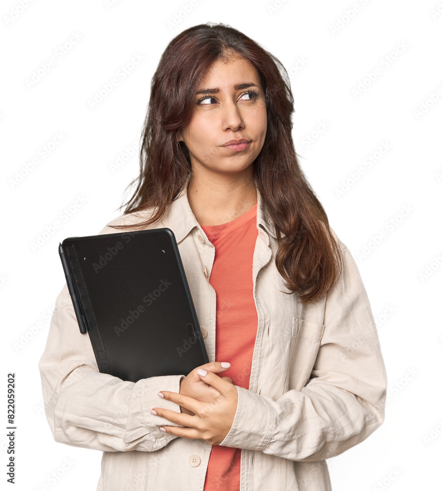 Middle Eastern woman with graphic tablet confused, feels doubtful and unsure. Middle Eastern woman with graphic tablet confused, feels doubtful and unsure.