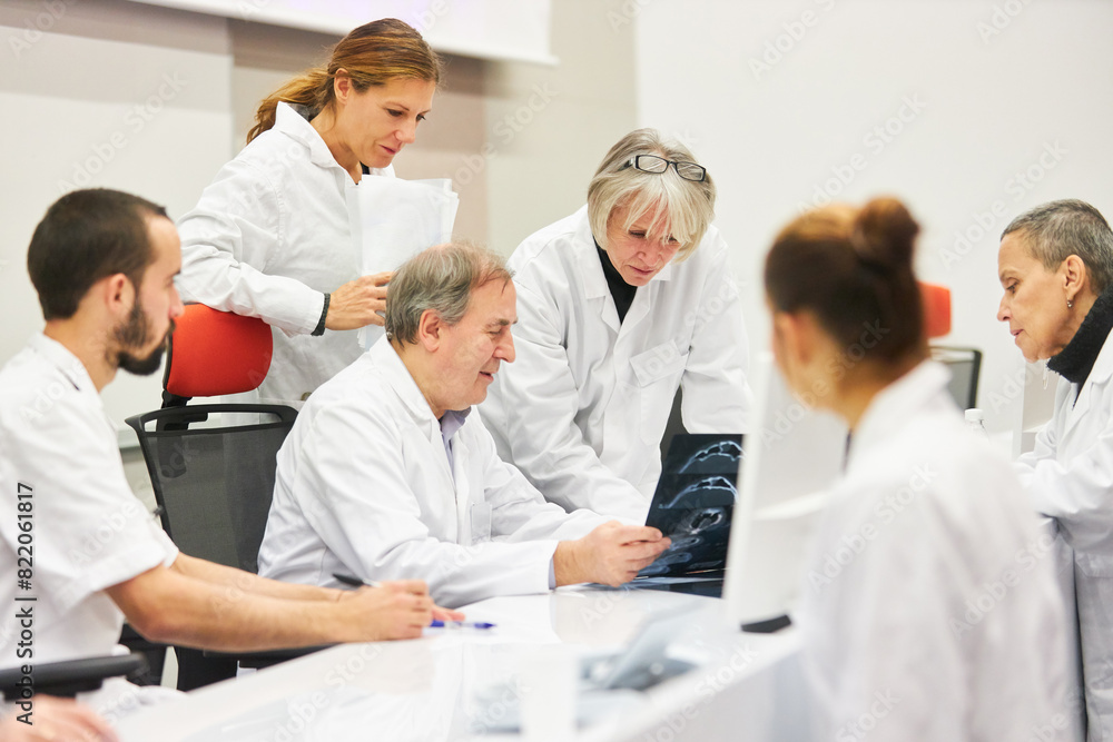 Doctors at medical conference discussing in auditorium Doctors at medical conference discussing in auditorium