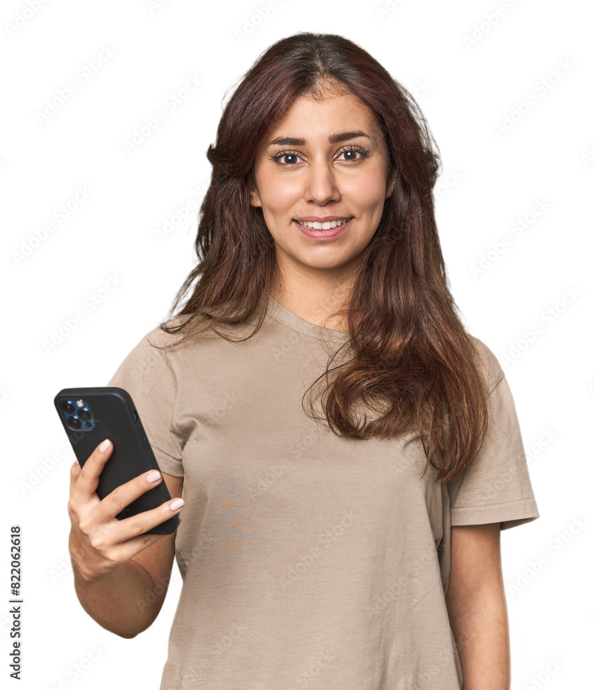 Young Middle Eastern woman holding a mobile in studio Young Middle Eastern woman holding a mobile in studio