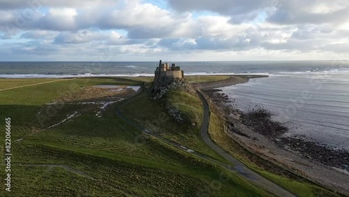 Drone footage of the Lindisfarne Castle on a coastal crag in Holy Island, Northumberland, England