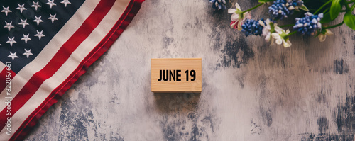 celebrating juneteenth with American flag and wooden date block on a textured background photo