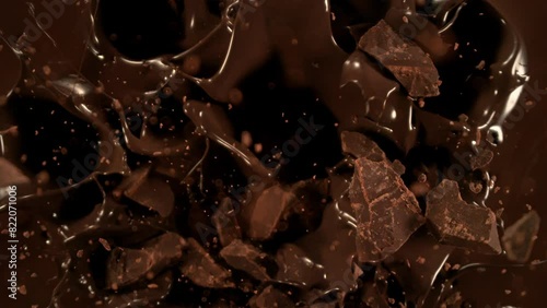 Super Slow Motion Shot of Chocolate Chunks Followed by Camera Falling into Chocolate Cream, 1000fps. photo