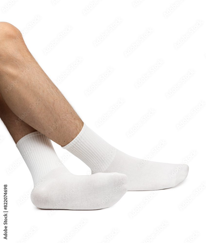 Male feet wearing white cotton socks on white background Male feet wearing white cotton socks on white background