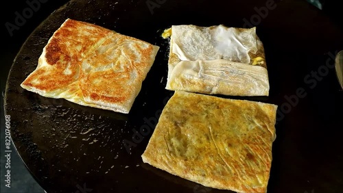 Footage of Cooking Roti Mataba or Murtabak, a Flavorful Pan Fried Spiced Beef Stuffed Pancake photo