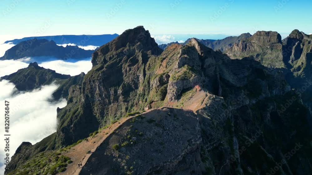 Aerial view of hikers on the hiking trail on Pico do Arieiro Mountain at sunset in Madeira, Portugal Aerial view of hikers on the hiking trail on Pico do Arieiro Mountain at sunset in Madeira, Portugal