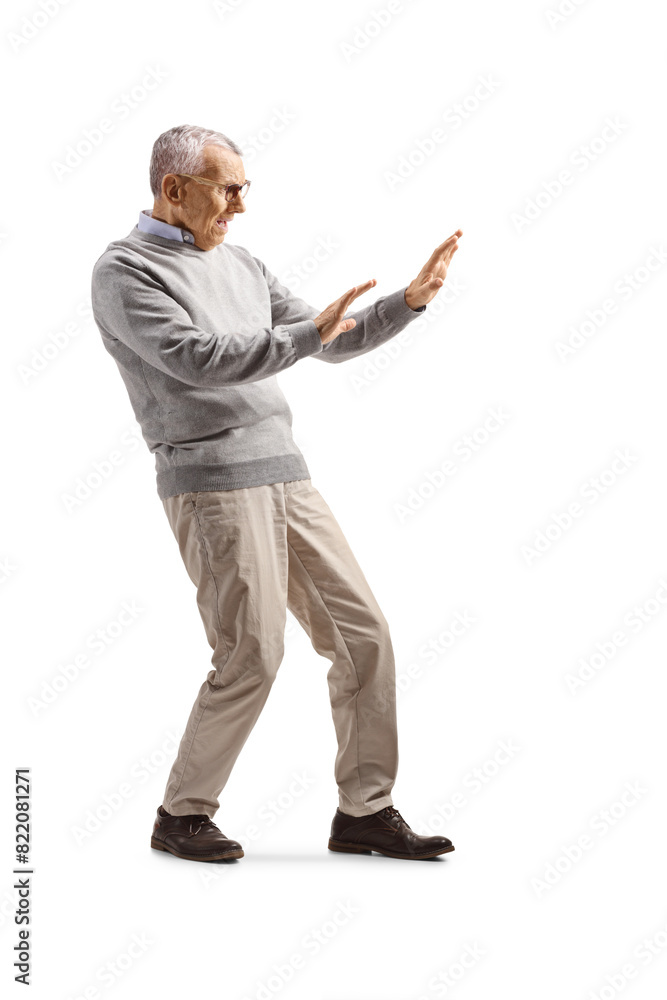 Full length shot of a scared mature man defending himself Full length shot of a scared mature man defending himself