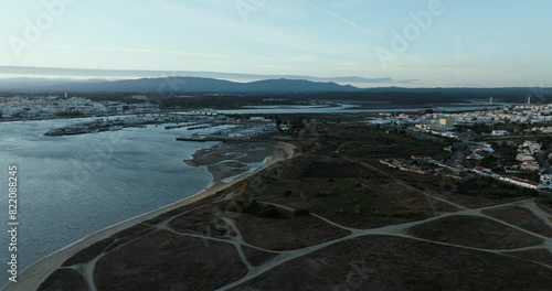 Aerial view of coastal town Ferragudo with Arade river and mountains, Algarve region, Portugal. photo