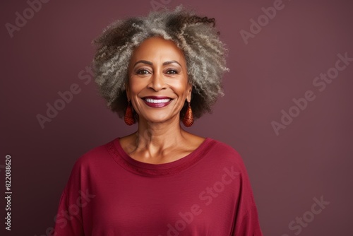 Maroon Background Happy black american independant powerful Woman. Portrait of older mid aged person beautiful Smiling girl Isolated on Background ethnic diversity 