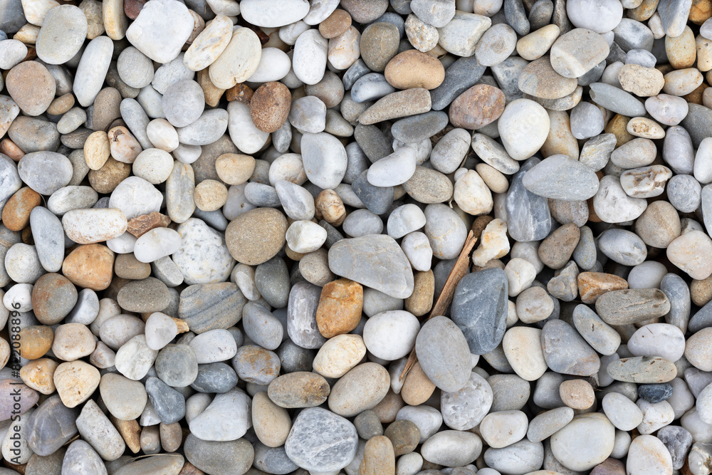 A detailed close-up image showcasing a variety of smooth river rocks in different shades and sizes, emphasizing textures A detailed close-up image showcasing a variety of smooth river rocks in different shades and sizes, emphasizing textures