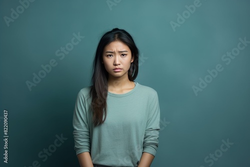 Mint background sad Asian Woman Portrait of young beautiful bad mood expression Woman Isolated on Background depression anxiety fear burn out health issue problem mental