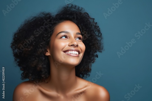 Navy background Happy black independant powerful Woman Portrait of young beautiful Smiling girl good mood Isolated on Background Skin Care Face Beauty 