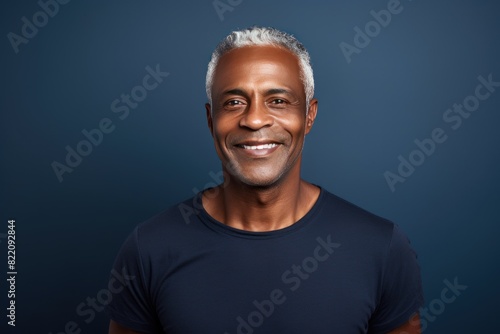Navy Background Happy black american independant powerful man. Portrait of older mid aged person beautiful Smiling boy Isolated on Background ethnic diversity