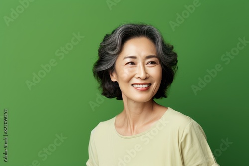 Olive Background Happy Asian Woman Portrait of Beautiful Older Mid Aged Mature Smiling Woman good mood Isolated Anti-aging Skin Care Face Beauty Product Banner with copyspace 