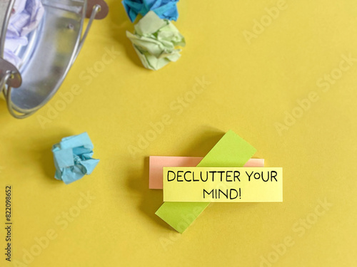 Declutter your mind on adhesive note paper background. Stock photo.