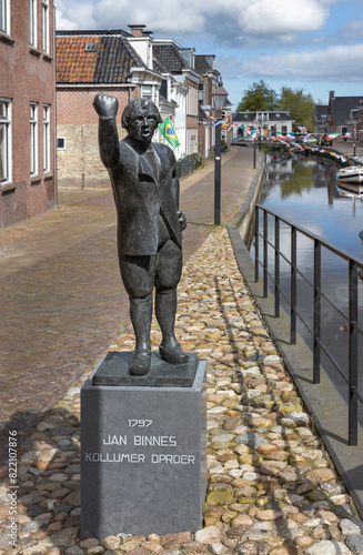 Statue of Jannes Ninnus. Kollumer oproer. History. and canal at Kollum. Village at Dutch countryside. Kollum Friesland Netherlands. photo