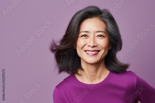 Purple Background Happy Asian Woman Portrait of Beautiful Older Mid Aged Mature Smiling Woman good mood Isolated Anti-aging Skin Care Face  © Zickert