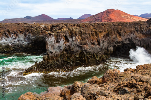 Cliffs of the steep volcanic coast of Los Hervideros. Lanzarote, Canary Islands, Spain photo