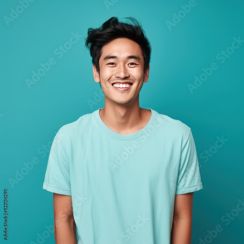 Turquoise Background Happy asian man realistic person portrait of young teenage beautiful Smiling boy good mood Isolated on Background ethnic diversity equality acceptance