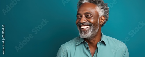 Turquoise Background Happy black american independant powerful man. Portrait of older mid aged person beautiful Smiling boy Isolated on Background ethnic diversity equality