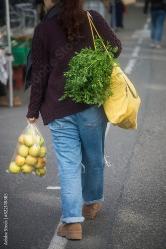 portrait on back view of woman carrying vegetables at the market