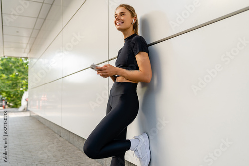 pretty young smiling woman doing sports in the morning in stylish black sport outfit sportswear, skinny strong body, healthy fit lifestyle