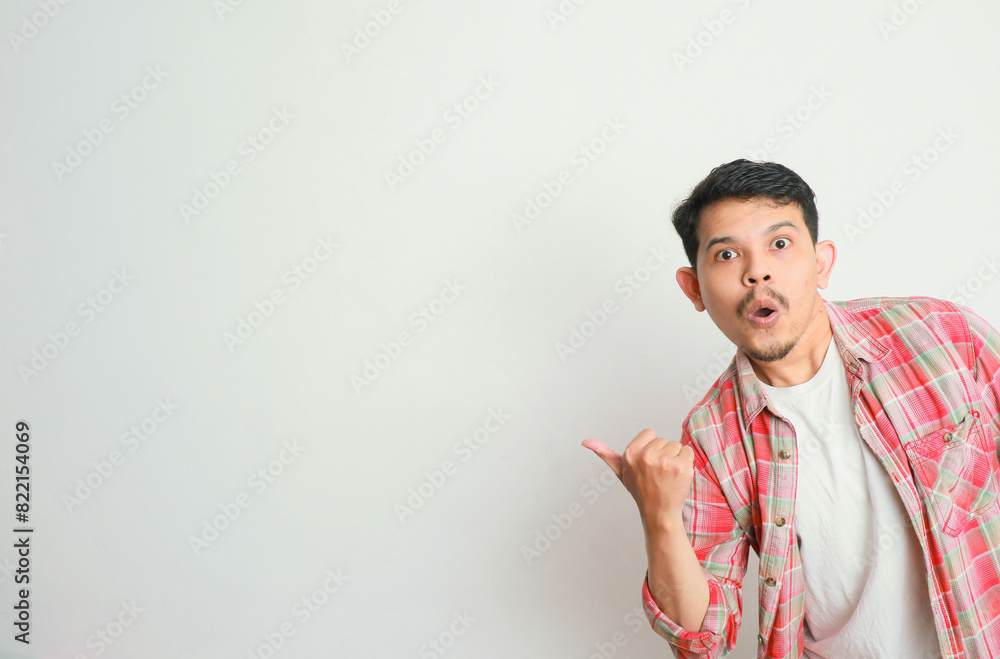an asian man smiles and points to something with his hand an asian man smiles and points to something with his hand