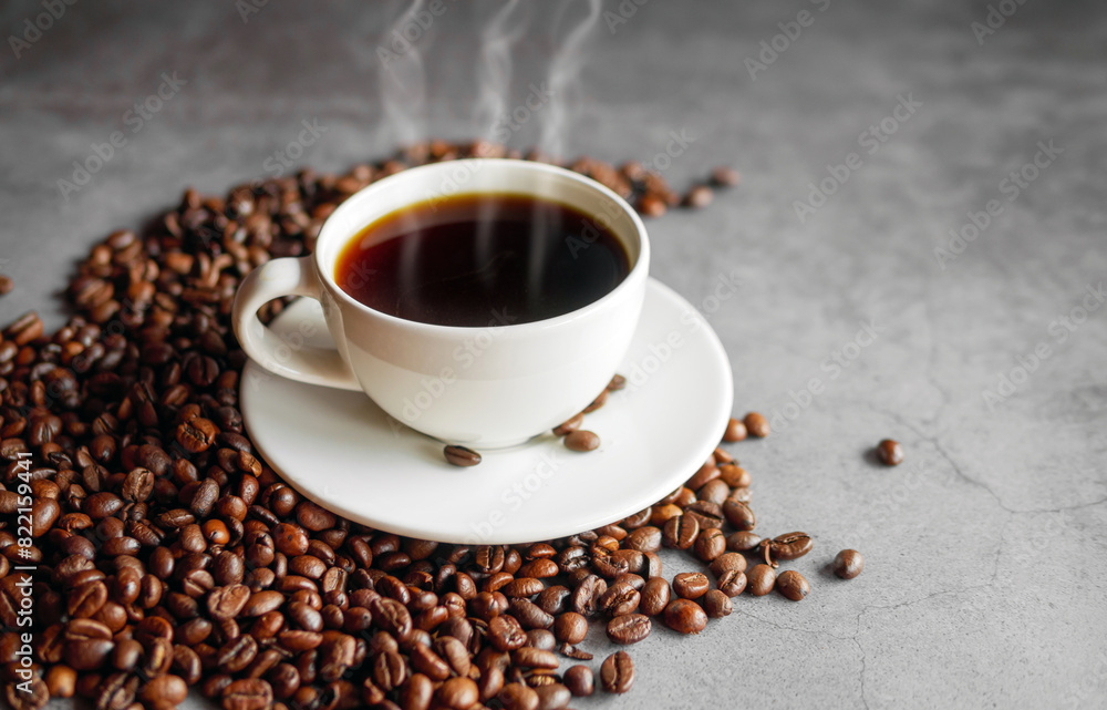 Coffee cup and coffee beans on gray background, Black coffee cup aromatic Coffee cup and coffee beans on gray background, Black coffee cup aromatic