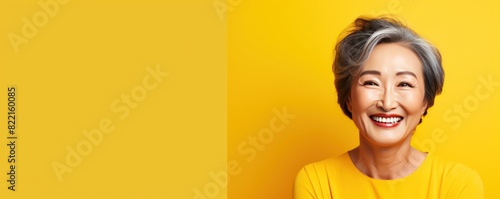 Yellow Background Happy Asian Woman Portrait of Beautiful Older Mid Aged Mature Smiling Woman good mood Isolated Anti-aging Skin Care Face Beauty Product Banner with copyspace blank 