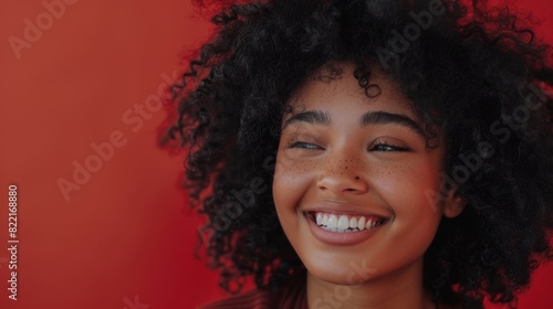 Attractive Black Girl with Lush Curly Hair Posing for Fashion Magazine Photoshoot. Smiles Playfully, Acts, Plays with Facial Expressions. Professional Studio Photograph.
