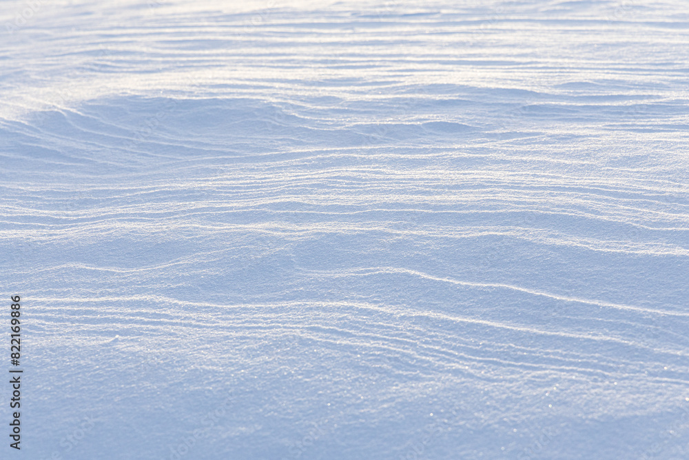 wind blown textured snow covers ground wind blown textured snow covers ground