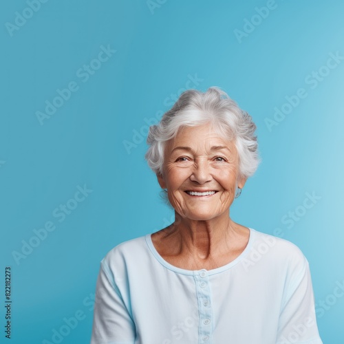 Blue background Happy european white Woman grandmother realistic person portrait of young beautiful Smiling Woman Isolated on Background Banner with copyspace 