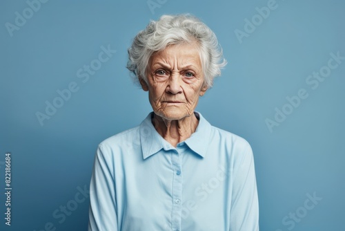 Blue background sad European white Woman grandmother realistic person portrait of young beautiful bad mood expression Woman Isolated Background depression anxiety fear burn  © Zickert