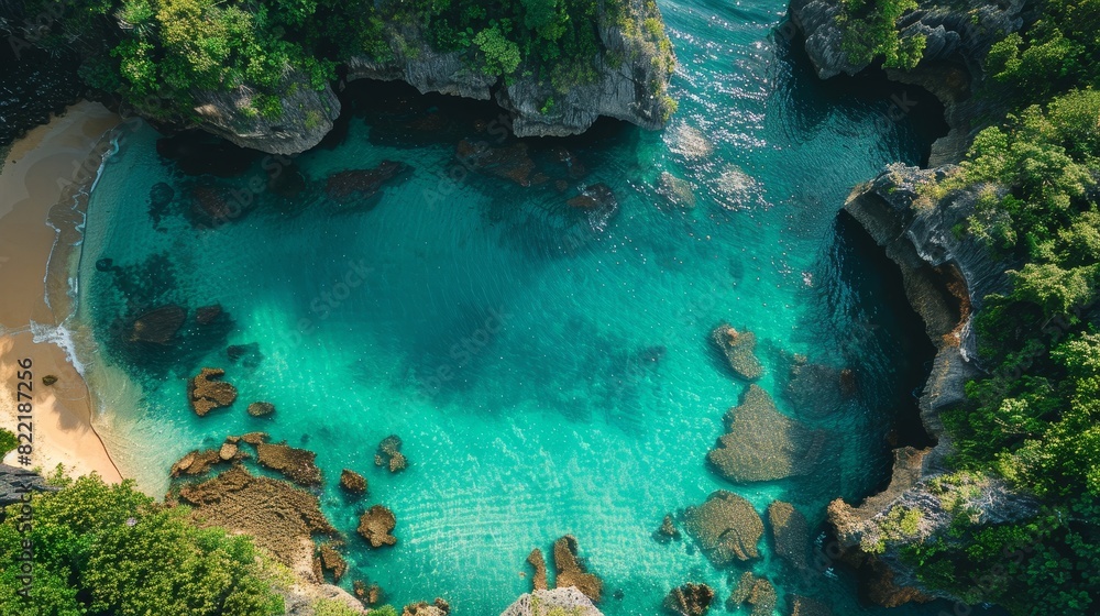 Aerial view of a pristine turquoise lagoon surrounded by rocky cliffs and lush greenery. Aerial view of a pristine turquoise lagoon surrounded by rocky cliffs and lush greenery.