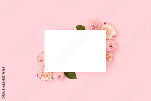 Empty paper card mockup. Rose flowers on a pink background. Place for text. © rorygezfresh