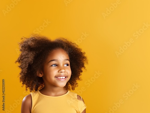 Gold background Happy black american african child Portrait of young beautiful kid Isolated on Background ethnic diversity equality acceptance concept with copyspace blank