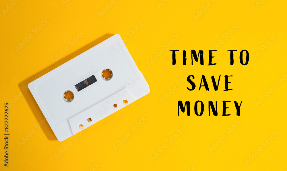A white cassette tape is on a yellow background A white cassette tape is on a yellow background